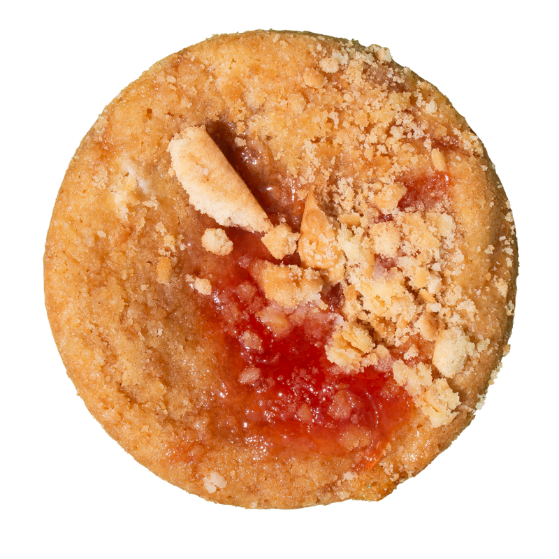 A single round crumb-topped pastry or cookie with red jam filling, shown from above on a plain white background.